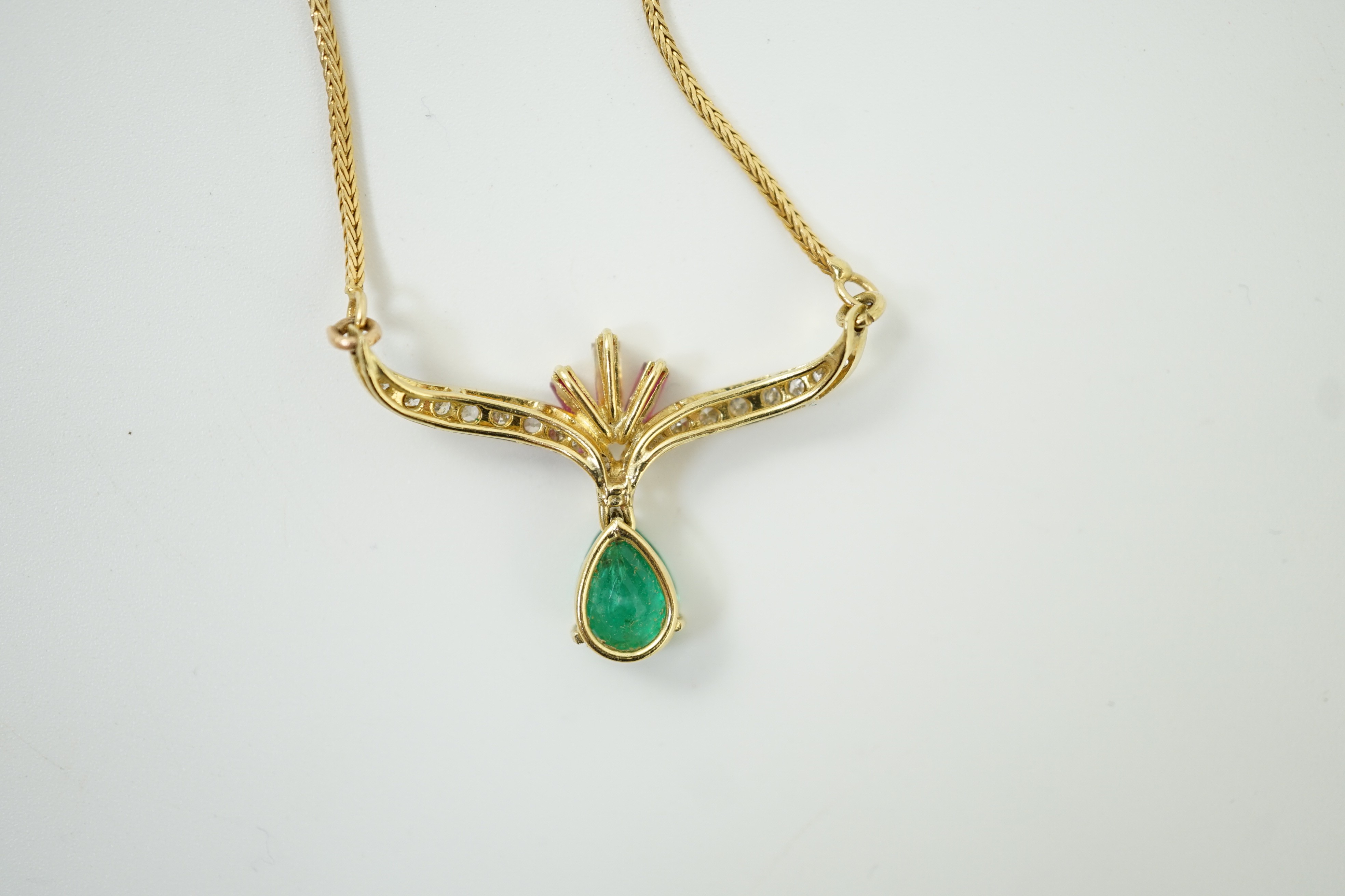 A modern Italian 750 yellow metal, emerald, ruby and diamond cluster set drop pendant, pendant width 35mm, chain 34mm, gross weight 7.3 grams.